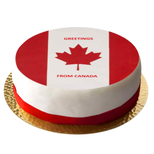 a cake with a topper that has a maple leaf and says greetings from canada