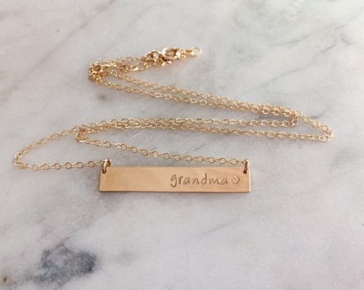 gold necklace with bar that states grandma