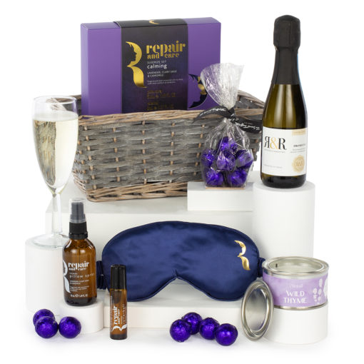 prosecco, a candle, a wellness set, chocolates, and a gift basket